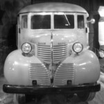This photo is one of our most treasured. It was given to us by the family of John Muse. This is the very first bus the Ferguson School District owned. When it was purchased from the Lexington dealership, it was the best bus in the county. Danville, Harrodsburg, Somerset and other small towns and cities did not even own buses, because their kids walked to school. The county systems tended to purchase the cheapest buses the state would allow. This, by comparison, was a Cadillac among school buses. Both the seats and backs were padded (most school buses back then had unpadded wooden seats and backs). The headlights were closed beams. Many of the school buses of the day did not even have headlights because they ran only in the daylight. The flowing lines of the fenders and hood were also considered ahead of their time since school buses back then tended to be quite boxy looking.
Notice the single small windshield wiper, the single small rear view mirror, and the stainless steel hand grip rails on both sides of the door.
Ferguson ran this bus for 10 years, then used it as a source of parts and a storage shed.