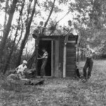 Five Ferguson boys build a clubhouse down along Pitman Creek from scrap lumber "borrowed" from a dismantled building on the outskirts of town. Pitman Creek ran along the eastern edge of the Ferguson school until it emptied into the lake.