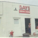 Gays Service Station might not look like much here, but it was one of the main cultural centers of Ferguson in the fifties and sixties. Kids not only came here for gas, but to work on their cars, buy inner tubes to take down to Pitman Creek, buy an RC Cola, or smoke a cigarette. If you wanted to find someone, you usually started here. Looking out the door is Marla Cooper Durham. Playing outside is Wayne Durham.