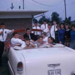 Members of the Class of 1961 take a break from "selling ads for the yearbook" at Finley's on a balmy April afternoon. From left to right Charles "Tink" Casada, Haskell Sullivan (driver), Sonny Denney (with face covered), Dolphus Price (black coat), Elwood Durham, Bobby Hamm (front passenger seat with face partially obscured), Johnny Cundiff (in back), Dickie Ford, John Raymond Beasley, Billy Fowler, Leonard Taylor, Lois Ann Young, Sue Coomer, Norma Galloway and Sandra Muse. Elwood was not in the Class of 1961, but had snuck out of school to grab a Finley Burger & Fries for lunch and ended up in the picture because he was a friend of Haskell. Haskell's red and white 1955 Chevy Bel Air convertible was one of the snazziest cars in Ferguson during his time in high school. It had naugahyde seats, one of the first stereo car radios, and a V-8 engine. It was a common sight at Finley's all year and at the local drive in movie during the Summer months. Ferguson School Archives - Students