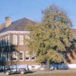Most photos of the school or the gym are from the front, but this angle shows the side and rear of the main building. Notice Mr. Copenhaver's 1953 truck, a well worn but reliable vehicle familiar to all Fergusonians in the 1950s. At this time, the administrative annex had not yet been built. There's a swing set barely visible along the right side of the photo.