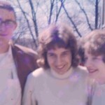 David Keith, Marilyn Yahnig and Peggy Lovins pause on the way home after another day of school. They are standing to the side of the building near the fire escape.