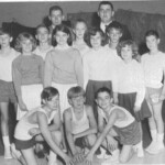 Shown here are the 1966-67 Ferguson Whiz Kids. Kneeling from left are guard Vernon Norris, forward Eddie Tucker and guard Gene Burton. Standing from left are guard Doug Strunk, forward Larry Burton, forward Ronnie Vaughn, forward Dennis Whitaker and guard Jerry Holsombach. Center Billy Brewster was not present for this photo. Coaches are Dan Omlor (left) and Woody Gosser. The cheerleaders are Opal Hamm, Janice Sadler, Jenna Lafavors and Sue Burton. Upon arriving in town, Omlor had to recruit each of these players by visiting them in their homes since school was already out for the Summer. Practice began June 1 and continued every morning from 9 am until noon, six days a week all Summer. Every Saturday they would scrimmage against another team from the county. By August word had begun to spread about this very special team, and the Commonwealth Journal sent a reporter and photographer out to do a major story. Even though he was only 12 years old in this photo and would never play for the high school, Norris remains one of the greatest shots in Ferguson history. Unguarded from half court he rarely missed and guarded he hit over 70%. The three kneeling became the front three on Ferguson's famous 1-2-1-1 full court zone press, which thanks to their quickness averaged over 30 steals a game. Ferguson had a 40 year history of great teams but this group was the only one to actually reach the State Tournament. Shown here are the 1966-67 Ferguson Whiz Kids. Kneeling from left are guard Vernon Norris, forward Eddie Tucker and guard Gene Burton. Standing from left are guard Doug Strunk, forward Larry Burton, forward Ronnie Vaughn, forward Dennis Whitaker and guard Jerry Holsombach. Center Billy Brewster was not present for this photo. Coaches are Dan Omlor (left) and Woody Gosser. The cheerleaders are Opal Hamm, Janice Sadler, Jenna Lafavors and Sue Burton. Upon arriving in town, Omlor had to recruit each of these players by visiting them in their homes since school was already out for the Summer. Practice began June 1 and continued every morning from 9 am until noon, six days a week all Summer. Every Saturday they would scrimmage against another team from the county. By August word had begun to spread about this very special team, and the Commonwealth Journal sent a reporter and photographer out to do a major story. Even though he was only 12 years old in this photo and would never play for the high school, Norris remains one of the greatest shots in Ferguson history. Unguarded from half court he rarely missed and guarded he hit over 70%. The three kneeling became the front three on Ferguson's famous 1-2-1-1 full court zone press, which thanks to their quickness averaged over 30 steals a game. Ferguson had a 40 year history of great teams but this group was the only one to actually reach the State Tournament.