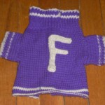 Fergie's Sweater. The Denney family graciously gave Coach Dan Omlor one of their German Shepherd pups. The cheerleaders in 1966-67 adopted the dog and included it in routines. Margaret Tucker knitted the dog this sweater to wear on game nights. After graduating from Ferguson, the dog lived for 16 years on the Omlor farm in Pennsylvania. Fergie is shown at right. Fergie's Sweater. The Denney family graciously gave Coach Dan Omlor one of their German Shepherd pups. The cheerleaders in 1966-67 adopted the dog and included it in routines. Margaret Tucker knitted the dog this sweater to wear on game nights. After graduating from Ferguson, the dog lived for 16 years on the Omlor farm in Pennsylvania. Fergie is shown at right.