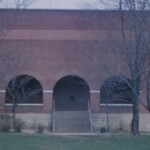 Ferguson Dedicates State Of The Art GymnasiumSomerset Commonwealth
October 15, 1928-----Ferguson School dedicated its magnificent new $19,000 gymnasium yesterday to a capacity crowd of 800. Built by local contractor George Elliott, the building is the finest basketball facility in the 12th Region except for the Centre College Field House, which hosts the annual State Tournament every March. The Ferguson Gym will become the home of the 47th District Tournament for the foreseeable future, it being unlikely any other school in the county will surpass it for a long time. The gym is of red brick, with a balcony above the west end of the basketball floor and a basement underneath the entire floor. The basement includes rest rooms, dressing rooms, lockers, showers, furnace room and coaching offices. The playing floor is of maple. It is 96 ft. by 55 ft., making it the largest high school floor in the state and actually equalling a standard college floor. The main building is 110 feet long, with a 45 ft. wide porch and ticket windows added to the front, facing Jacksboro Road. There are three half circle arches, one over each entrance and one over the large window. Braces and main beams are in place to add balconies on both sides, allowing for future expansion. Six large windows border each side of the main floor, placed high enough to be above those potential balconies. Five steel trusses arch 30 feet above the floor, providing more clearance than even the Centre Field House. Six windows line each side of the basement, with two along the front under the porch. The lighting over the playing floor is very bright, and additional lights illuminate the entries, porch and basement. Rows of raised seats line both sides of the floor, each extending end line to end line. Perhaps the most memorable feature of the entire building is the electric scoreboard. The first of its kind in the region, the clock, scores and even the quarters are controlled by an operator seated at midcourt. There is no need for a student to stand on a ladder and turn wheels or use chalk and eraser. Players and officials will appreciate the end zone clearance. There is a full five feet from the edge of the playing surface to the wall on both ends, a welcome relief from those many gyms where the walls are the out of bounds lines and the backboards are mounted flush with the walls. All in all, the gym is a great advance for basketball in Pulaski County and the 12th Region. State of the Art Gymnasium