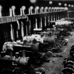 This is the interior of the engine shop, which is the furthest building on the left in the photo of the whole yard. This is the larger of the two sections of the building. You can see eight full sized engines in for servicing. Engines are stripped down to the boiler, which, because of the high pressure and intense heat, would need to be repaired or replaced every 100,000 miles. This photo was taken on a Sunday afternoon, when the shops were closed. During the week, they would have been bustling with activity. A crew of six worked on each engine: a fully certified mechanical engineer who served as foreman, two welders, two metalworkers, and a pipefitter. The pipefitter's job was to perfect the seals. There were over a hundred seals where various metal parts came together. Any leaking seal meant a return to the shop, which the railroad could not afford. It could take up to a month to recondition a full sized steam engine if it was in bad condition, but they could usually redo one in two or three weeks.